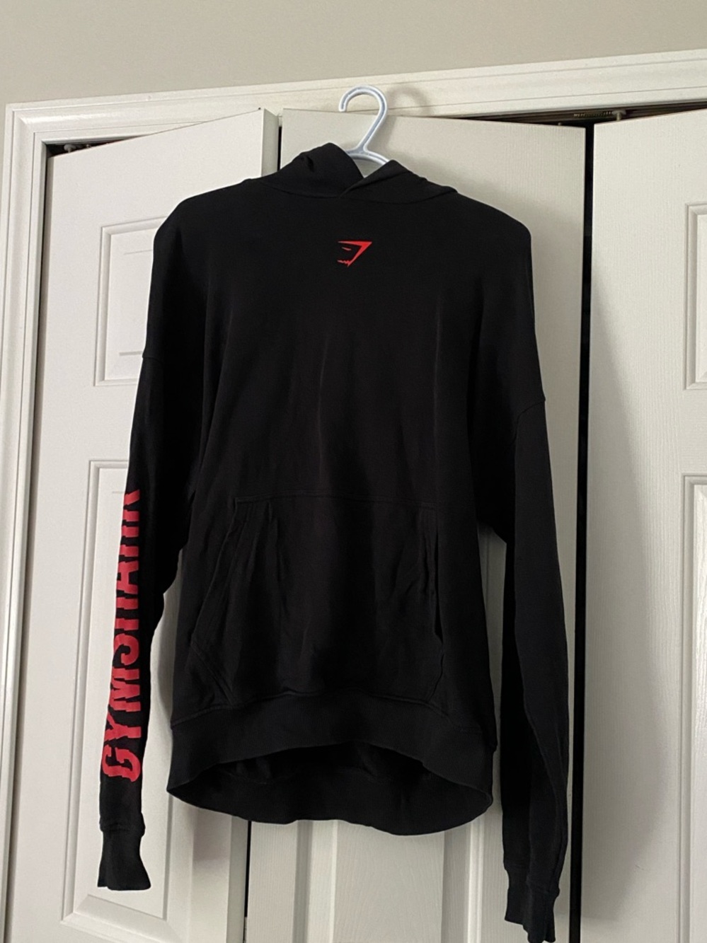 Gymshark Black Hoodie with Red Sleeve Logo
